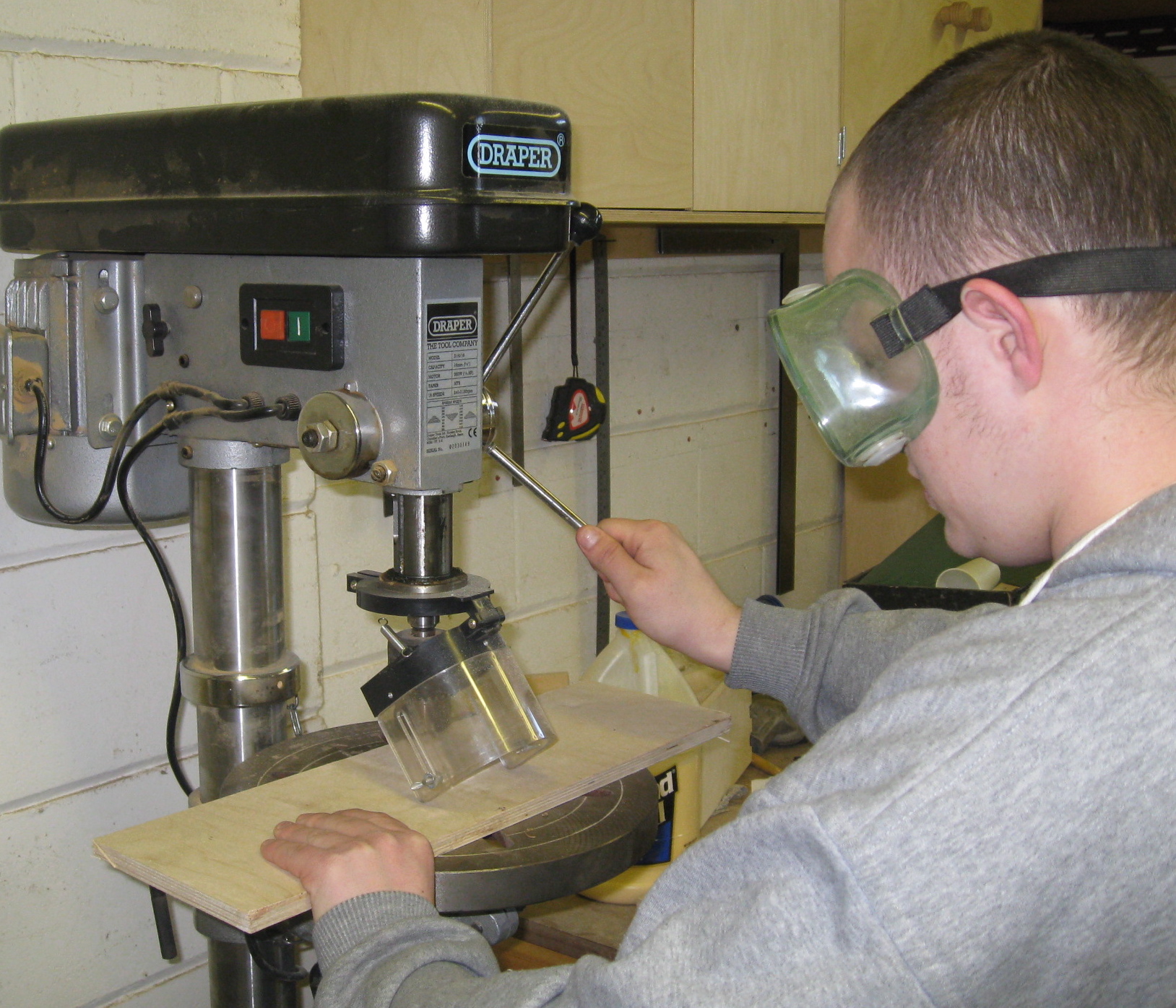 Young person using pillar drill
